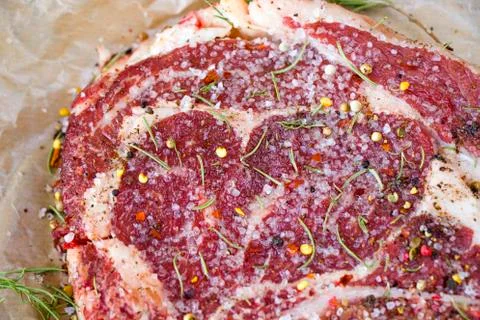 Raw beef meat on the table, spices and Rosemary, Rib eye steak ingredients. P Stock Photos