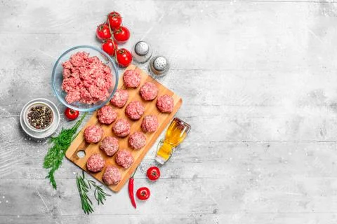 Raw beef meatballs with spices and fragrant dill . Stock Photos