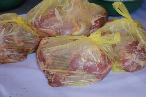 Raw beef packed in yellow plastics Stock Photos