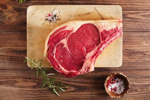 Raw beef Rib bone  steak   on wooden board and table Stock Photos