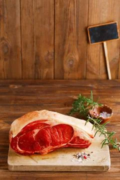 Raw beef Rib bone  steak   on wooden board and table Stock Photos