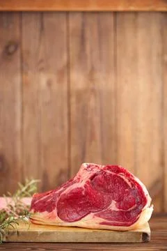Raw beef Rib steak with bone on wooden board and table Stock Photos