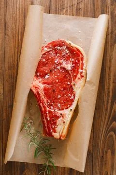 Raw beef Rib steak with bone on wooden board and table Stock Photos