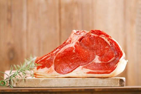 Raw beef Rib steak with bone on wooden board and table Stock Photos