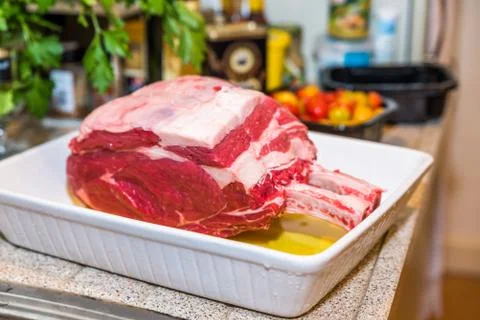 Raw beef Rib steak with bone in roasting tray on wooden table 스톡 사진