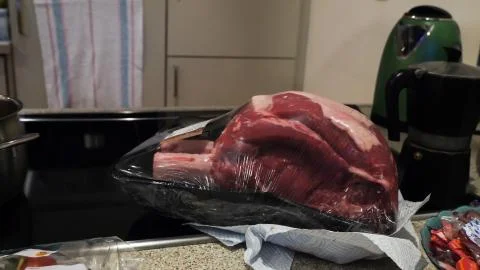 Raw beef Rib steak with bone in shop packaging on wooden table 库存照片