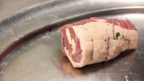 Raw beef roulade resting on a stainless steel tray Stock Footage 336229803