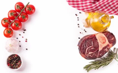 Raw beef steak with bone and ingredients for cooking isolated on white. Foto stock