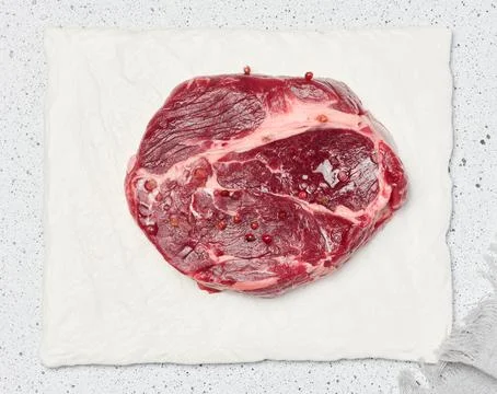 Raw beef steak chuck eye roll on a white board 스톡 사진