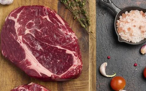Raw beef steak chuck eye roll on wooden board. Spices for cooking Himalayan Stock Photos