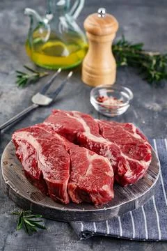 Raw beef steak on dark gray background Stock Photos