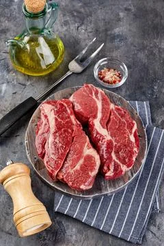 Raw beef steak on dark gray background Stock Photos