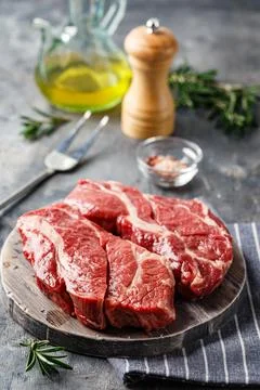 Raw beef steak on dark gray background Stock Photos