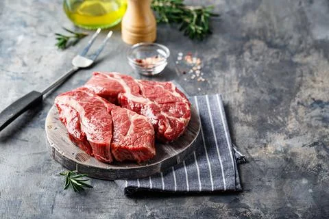 Raw beef steak on dark gray background Stock Photos