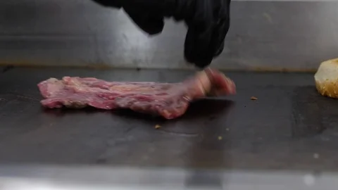 Raw beef steak grilled on the grill. Preparing of the burger Stock Footage 86177929