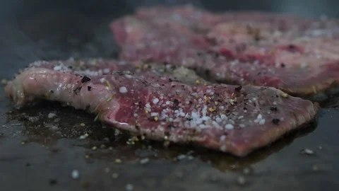 Raw beef steak grilled on the grill. Preparing of the burger Stock Footage 86177940