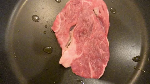 Raw beef steak grilling Stock Footage 132124477