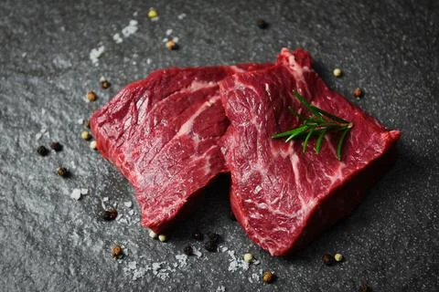 Raw beef steak with herb and spices - Fresh meat beef sliced on black backg.. Stock Photos