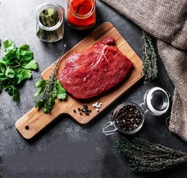 Raw beef steak with herbs Stock Photos