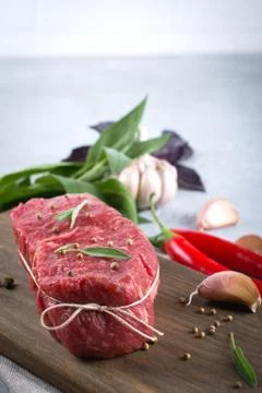 Raw beef steak with ingredients for cooking on cutting board . Stock Photos