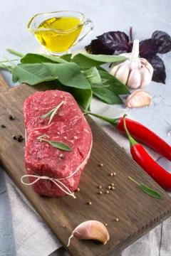Raw beef steak with ingredients for cooking on cutting board . Stock Photos