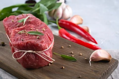 Raw beef steak with ingredients for cooking on cutting board . Stock Photos