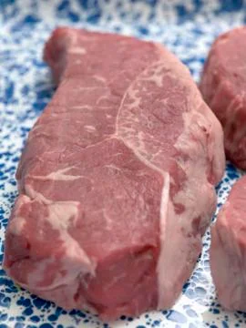 Raw beef steak on patterned plate 스톡 사진