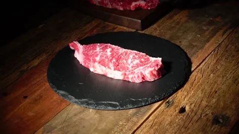 Raw Beef Steak Plating on Black Dish Stock Footage 334909404