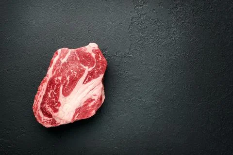 Raw beef steak. Raw fresh Chuck roll steak with rosemary, salt and pepper o.. Stock Photos