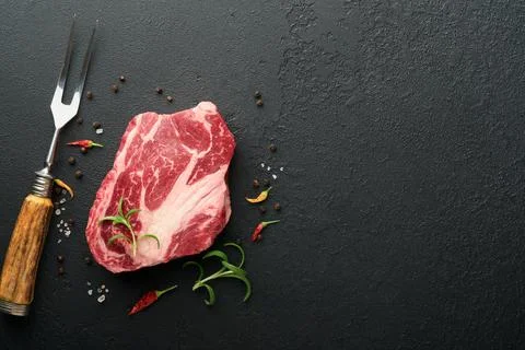Raw beef steak. Raw fresh Chuck roll steak with rosemary, salt and pepper on  Stock Photos