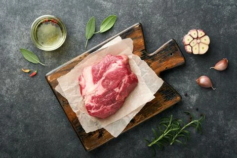 Raw beef steak. Raw fresh Chuck roll steak with rosemary, salt and pepper on  Stock Photos