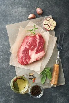 Raw beef steak. Raw fresh Chuck roll steak with rosemary, salt and pepper on  Stock Photos