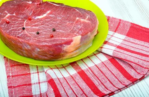 Raw beef steak with red pepper. Stock Photos