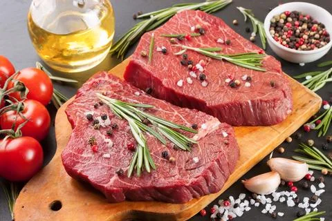 Raw beef steak with spice Stock Photos