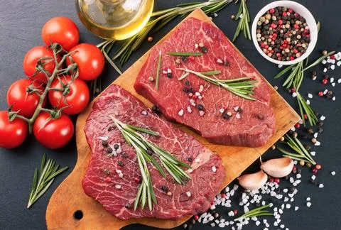 Raw beef steak with spice Stock Photos