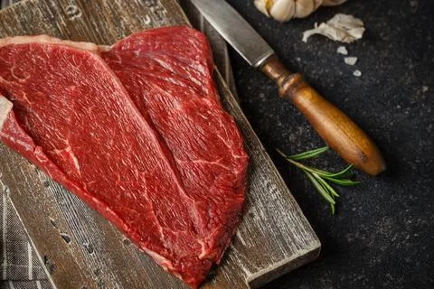 Raw beef steak with spices. Stock Photos