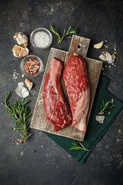 Raw beef steak with spices. Stock Photos