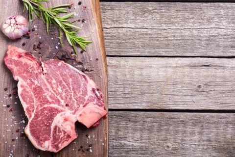 Raw beef steak T bone with ingredient Stock Photos