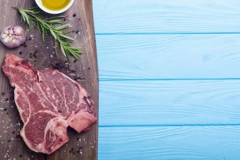 Raw beef steak T bone with ingredient Stock Photos