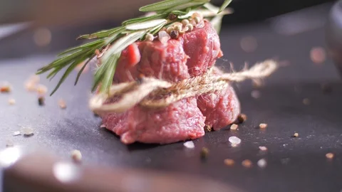 Raw beef steak tied with twine. Preparing filet mignon Stock Footage 106923494
