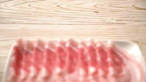 Raw beef steak on a wooden surface ready for cooking Stock Photos