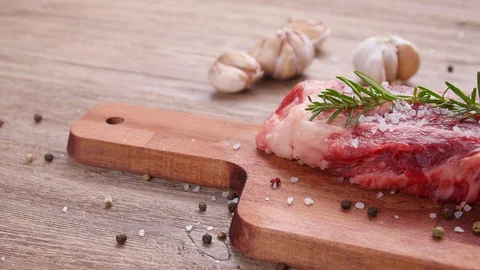 Raw beef steak on a wooden table Stock Footage 123283408