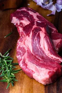 Raw beef steaks, herbs and cooking ingredients, food cooking. Stock Photos