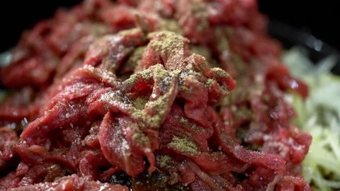 Raw beef stroganoff on a plate, sprinkled with spices. Stock Footage 159368641