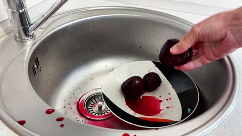 Raw Beets in White Plate, Red Juice Splattered Across Sink Video stock 321049134