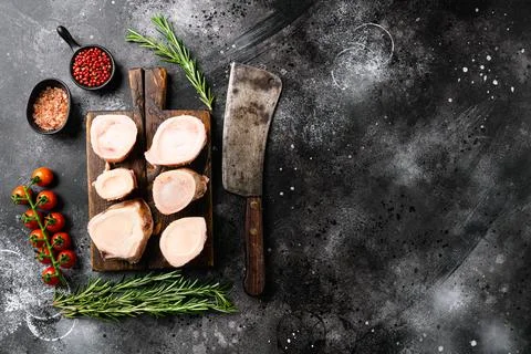 Raw bone cut veal beef, on black dark stone table background, top view flat l Stock Photos