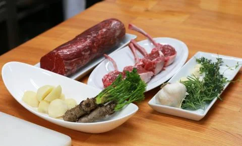 Raw boneless beef, bone rib-eye steak  with onion, garlic and garnish Stock-Fotos
