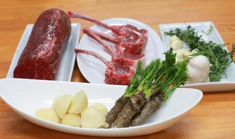 Raw boneless beef, bone rib-eye steak with onion, garlic and garnish Stock-Fotos