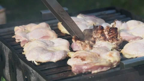 Raw boneless chicken drums on barbeque close up Stock Footage 335695241