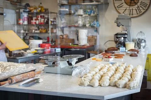 Raw bread dough portions on a table in a commercial bakery. Food production.. Stock Photos